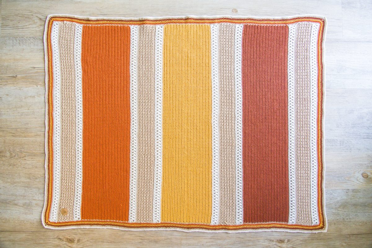 crochet blanket in cream orange yellow and white stripes