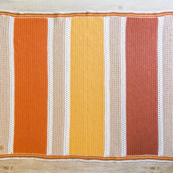 crochet blanket in cream orange yellow and white stripes