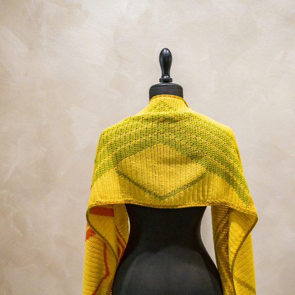 yellow crochet scarf on a mannequin