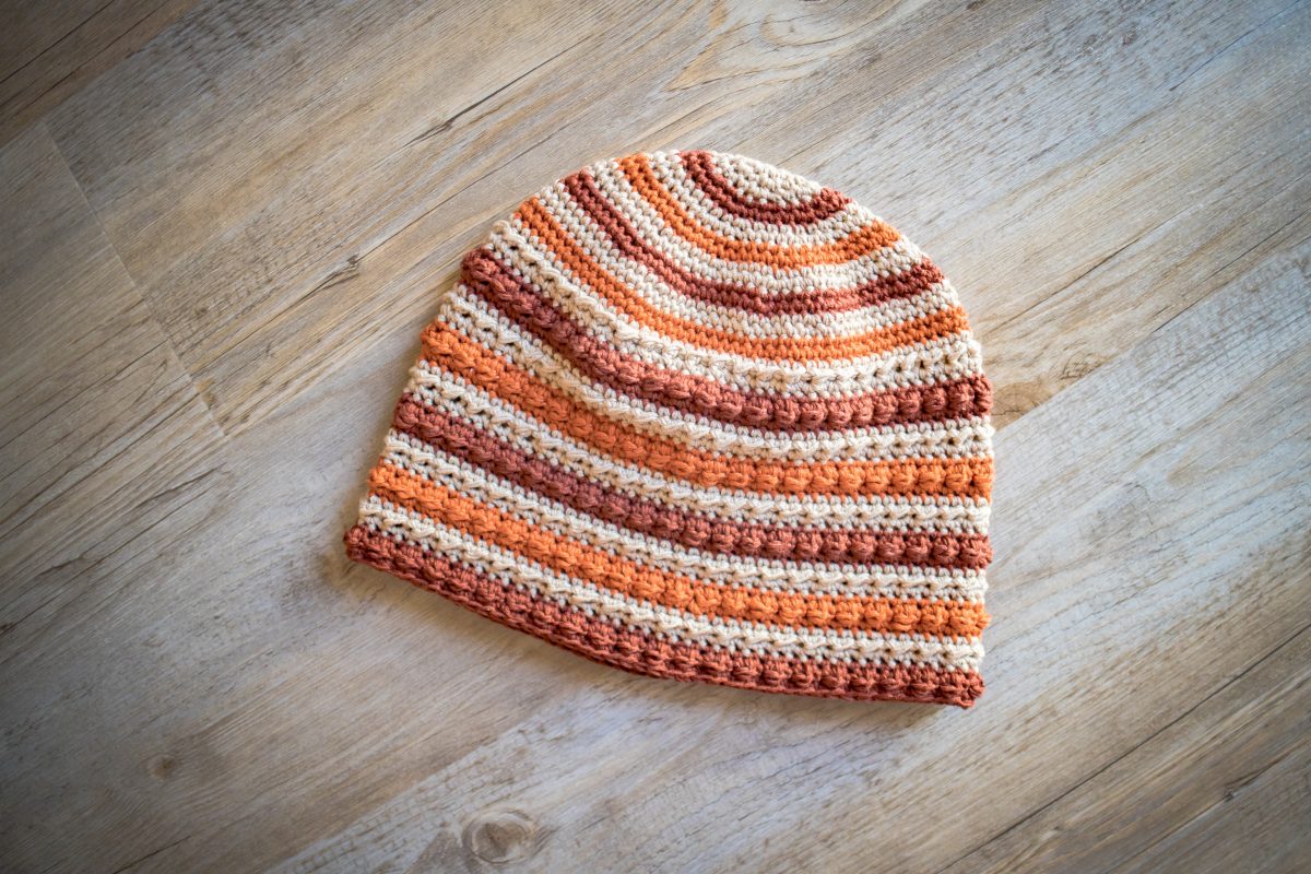 crochet hat in stripes of orange brown and beige