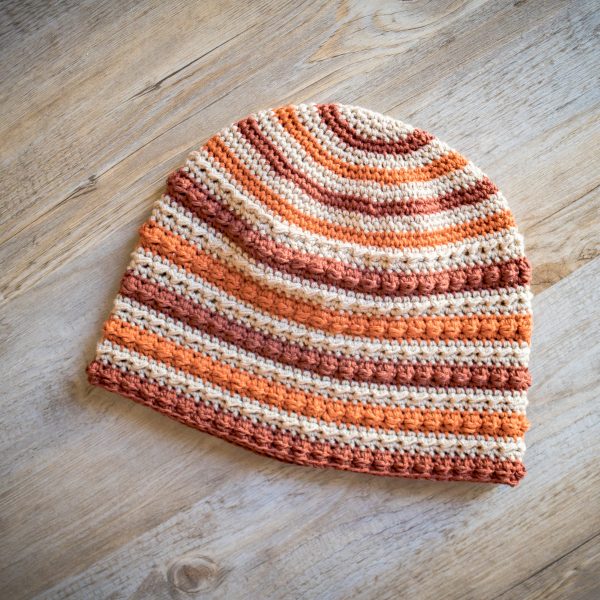 crochet hat in stripes of orange brown and beige