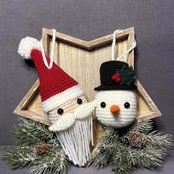 two crochet ornaments - Santa Clause and Snowman hanging from a star shaped wooden tray