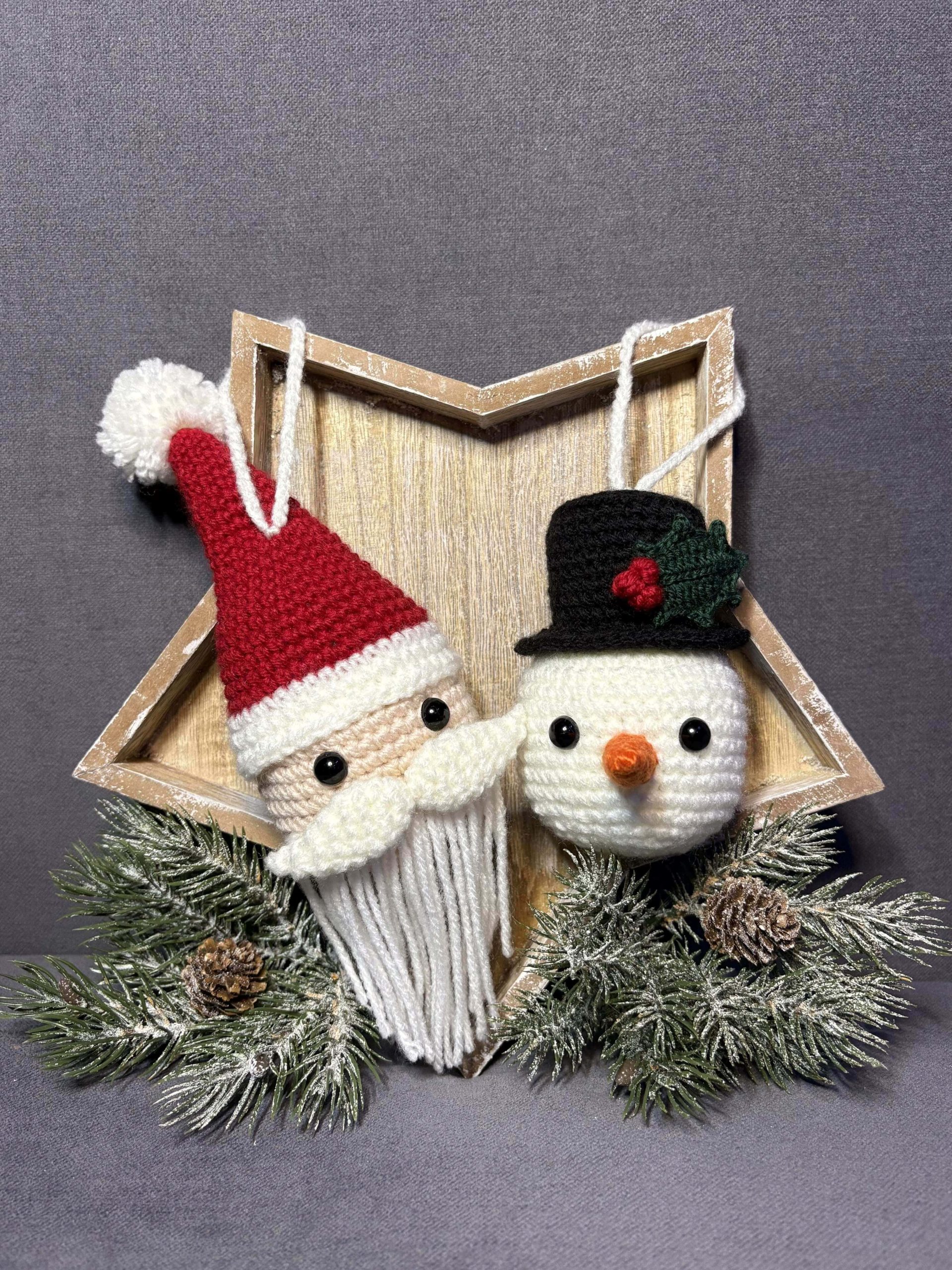 two crochet ornaments - Santa Clause and Snowman hanging from a star shaped wooden tray